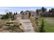 Beautiful home showcasing a stone facade, three-car garage, and lush landscaping at 6398 Lost Canyon Ranch Rd, Castle Rock, CO 80104