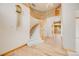 Elegant foyer features a curved staircase, light hardwood floors and a chandelier at 6398 Lost Canyon Ranch Rd, Castle Rock, CO 80104