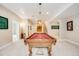 Spacious game room with a pool table and neutral paint and carpet throughout at 6398 Lost Canyon Ranch Rd, Castle Rock, CO 80104