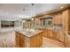 Open kitchen boasts a large island with granite countertops and light wood cabinets at 6398 Lost Canyon Ranch Rd, Castle Rock, CO 80104