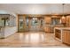 Open kitchen and dining area with wood floors, cabinets, and ample natural light at 6398 Lost Canyon Ranch Rd, Castle Rock, CO 80104