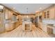 Spacious kitchen with wood cabinets, stainless steel appliances, and a central island at 6398 Lost Canyon Ranch Rd, Castle Rock, CO 80104