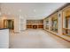Bright living room with stone fireplace and large windows that bring in lots of natural light at 6398 Lost Canyon Ranch Rd, Castle Rock, CO 80104