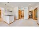 Bright living room with a partial kitchen with modern pendant lights and wood trim throughout at 6398 Lost Canyon Ranch Rd, Castle Rock, CO 80104