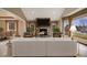 Comfortable living space with stone fireplace, neutral tones, and view of the dining room at 6398 Lost Canyon Ranch Rd, Castle Rock, CO 80104