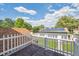 Backyard with solar panels on detached garage, white picket fence, and beautiful trees overhead on a sunny day at 1100 S Garfield St, Denver, CO 80210