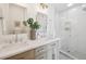 Bright bathroom with double sink vanity, modern lighting, and glass enclosed shower at 1100 S Garfield St, Denver, CO 80210