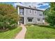 Charming gray two-story home with a manicured lawn and inviting walkway at 1100 S Garfield St, Denver, CO 80210