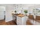 Open-concept kitchen with modern appliances, gas range, and stylish lighting at 1100 S Garfield St, Denver, CO 80210