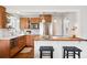 Well-lit kitchen with wooden cabinets, stainless steel appliances, and butcher block counter at 1100 S Garfield St, Denver, CO 80210