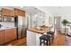 Modern kitchen with stainless steel appliances and butcher block island with seating at 1100 S Garfield St, Denver, CO 80210