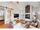 Bright living room features a fireplace with a modern wood accent, hardwood floors and sliding barn door at 1100 S Garfield St, Denver, CO 80210