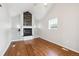 Bright living room with vaulted ceilings, hardwood floors, fireplace, and custom built-in shelving at 1100 S Garfield St, Denver, CO 80210