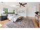 Spacious main bedroom with a ceiling fan, natural light, hardwood floors, and neutral decor at 1100 S Garfield St, Denver, CO 80210