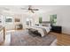 Bright main bedroom with a ceiling fan, neutral decor, hardwood floors, and access to a balcony at 1100 S Garfield St, Denver, CO 80210