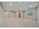 Spacious basement area with carpet flooring, natural light and multiple access doors at 4880 River Landing Ave, Firestone, CO 80504