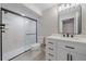 Modern bathroom featuring a glass door shower and large vanity with sink at 4880 River Landing Ave, Firestone, CO 80504
