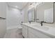 Bright bathroom featuring double sinks, modern mirrors, and a tiled shower/tub at 4880 River Landing Ave, Firestone, CO 80504
