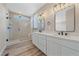 Bright bathroom with double vanity, walk-in shower, and modern fixtures at 4880 River Landing Ave, Firestone, CO 80504