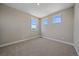 Bright bedroom offering three windows with natural light and carpet flooring at 4880 River Landing Ave, Firestone, CO 80504