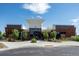 Modern clubhouse exterior with contemporary design, complemented by attractive landscaping and clear blue skies at 4880 River Landing Ave, Firestone, CO 80504