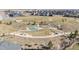 Aerial view of the neighborhood park including playground, recreational space, and walking paths at 4880 River Landing Ave, Firestone, CO 80504
