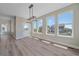 Sunny dining room with a back door and large windows providing backyard views at 4880 River Landing Ave, Firestone, CO 80504