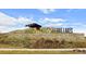 Entrance sign to the community, surrounded by stonework and landscaping at 4880 River Landing Ave, Firestone, CO 80504