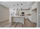 Modern kitchen featuring white cabinets, a center island, and sleek pendant lighting at 4880 River Landing Ave, Firestone, CO 80504