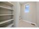 Functional laundry room with built-in shelving and natural light at 4880 River Landing Ave, Firestone, CO 80504