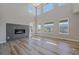 Bright living room with a contemporary fireplace, high ceilings, and plenty of natural light at 4880 River Landing Ave, Firestone, CO 80504