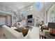 Bright, open living room with fireplace, high ceilings, and modern staircase at 4880 River Landing Ave, Firestone, CO 80504
