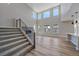 Spacious living room with soaring ceilings, a modern fireplace, and large windows at 4880 River Landing Ave, Firestone, CO 80504