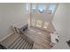 Aerial view of the living room, modern fireplace, stairs, and sun-filled kitchen in new construction home at 4880 River Landing Ave, Firestone, CO 80504