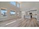 Bright, open floor plan with high ceilings, large windows, connecting living room and kitchen at 4880 River Landing Ave, Firestone, CO 80504
