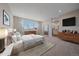 Bright main bedroom boasting large windows, dresser, and an ensuite bathroom at 4880 River Landing Ave, Firestone, CO 80504
