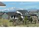 A picturesque neighborhood with mountain views, well-maintained homes and lush greenery at 4880 River Landing Ave, Firestone, CO 80504