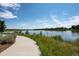 Scenic community pond view with walking path, calm water, and natural surroundings on a sunny day at 4880 River Landing Ave, Firestone, CO 80504