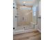 Contemporary shower with glass door, bench, and decorative tile at 4880 River Landing Ave, Firestone, CO 80504