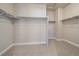 Walk-in closet features shelving for storage, and neutral carpeting, offering an organized space at 4880 River Landing Ave, Firestone, CO 80504
