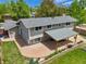 Aerial view of backyard, featuring covered patio, well-maintained lawn, and landscaping at 13030 King Cir, Broomfield, CO 80020