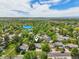 Community aerial view with playground, with lush green trees under a cloudy blue sky at 13030 King Cir, Broomfield, CO 80020