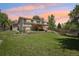 Expansive backyard featuring a covered patio, lush green lawn, and mature landscaping at 13030 King Cir, Broomfield, CO 80020
