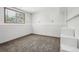 Unfinished basement with carpet, window, and a partially finished wall with storage at 13030 King Cir, Broomfield, CO 80020