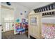Whimsical bedroom with house-shaped bed frame, decorated with a dollhouse and ceiling stars at 13030 King Cir, Broomfield, CO 80020