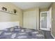 Comfortable bedroom features a patterned duvet, floating shelves, and a glass panel door at 13030 King Cir, Broomfield, CO 80020