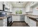 Efficient kitchen with stainless appliances, white cabinets, and a bright, natural light at 13030 King Cir, Broomfield, CO 80020