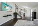 Bright living room featuring dark hardwood floors, staircase and a mounted television at 13030 King Cir, Broomfield, CO 80020