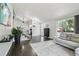 Bright living room featuring dark hardwood floors, staircase and large windows at 13030 King Cir, Broomfield, CO 80020