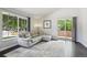 Bright living room with hardwood floors, modern sofa, and large windows overlooking the exterior at 13030 King Cir, Broomfield, CO 80020